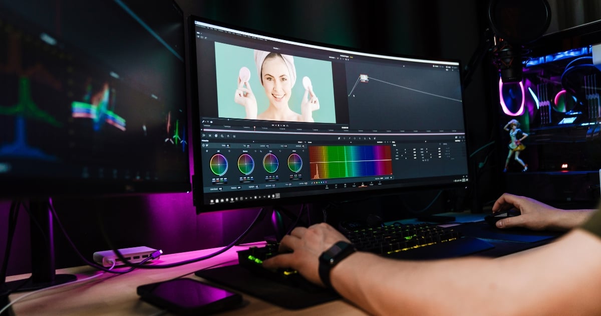 Home » Latest Printing News A person using a dual-monitor setup to colour grade a video of a woman